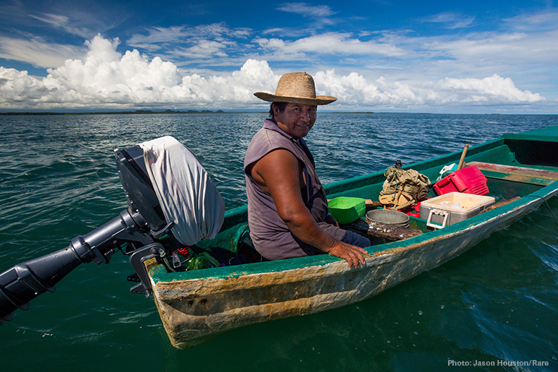 A fisherman handlines from his small panga off the coast of Punta Gorda, Belize. A full cooler of small snapper might be worth $100 for his day of work. Photo © Jason Houston/Rare