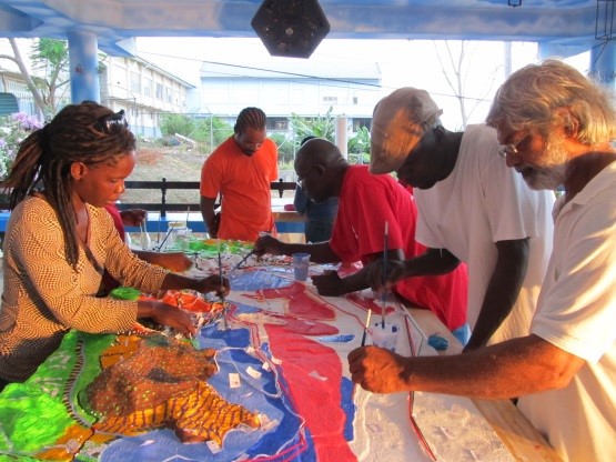 Community members construct a 3D model of the surrounding villages and the Bay of Grenville, highlighting existing natural and cultural resources. Photo © TNC