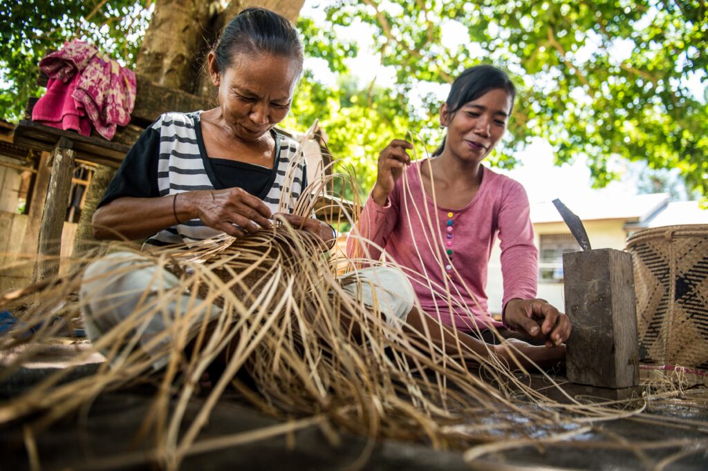 Villagers weave baskets made from rattan, Borneo, Indonesia.