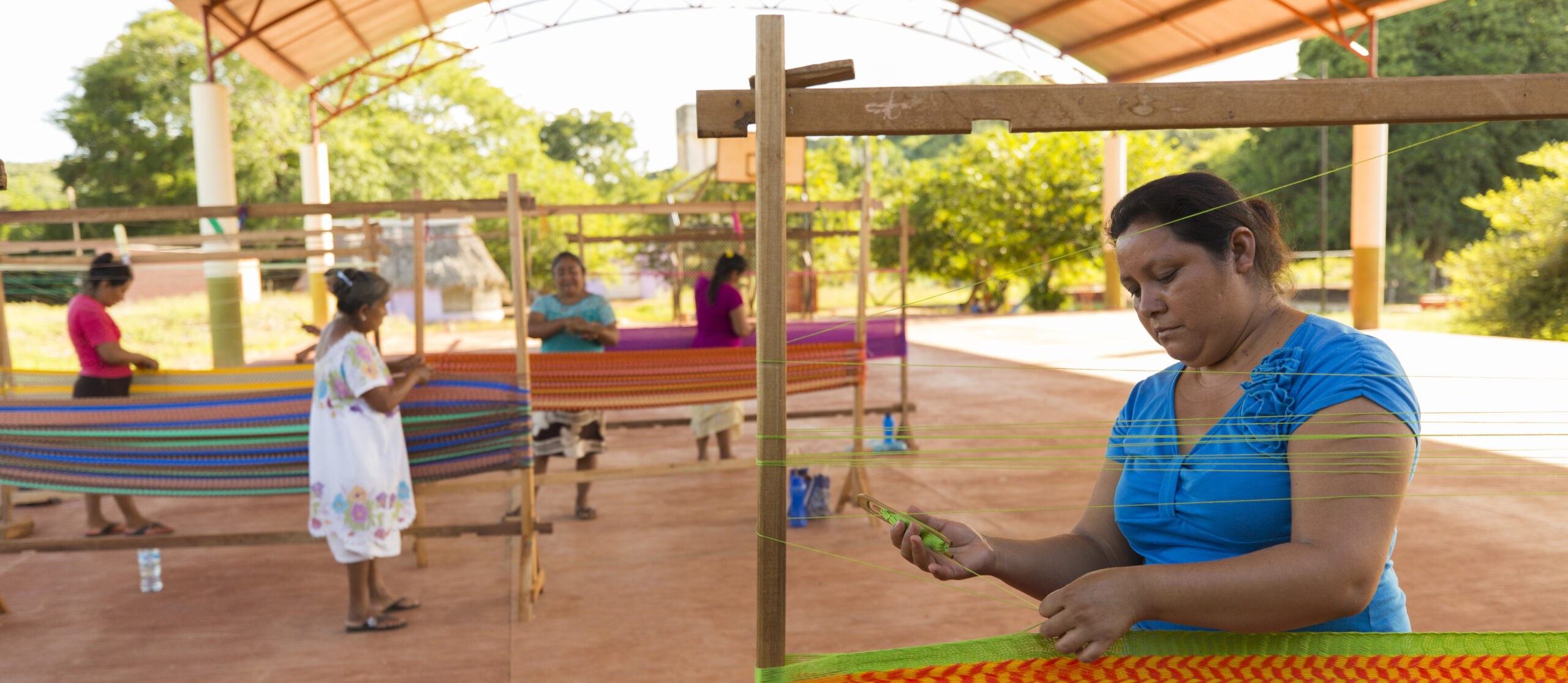 Women from the San Agustin ejido cooperative weave traditional Mayan hammocks, Yucatan, Mexico.