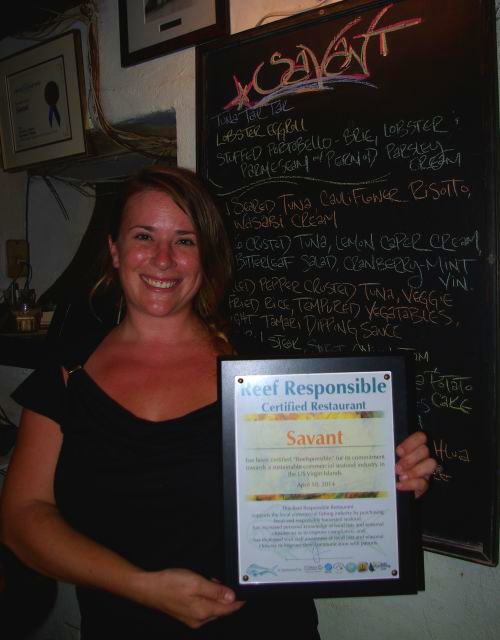 Hostess Sarah with the Reef Responsible plaque at restaurant Savant, a certified Reef Responsible Restaurant on St. Croix. Photo © TNC