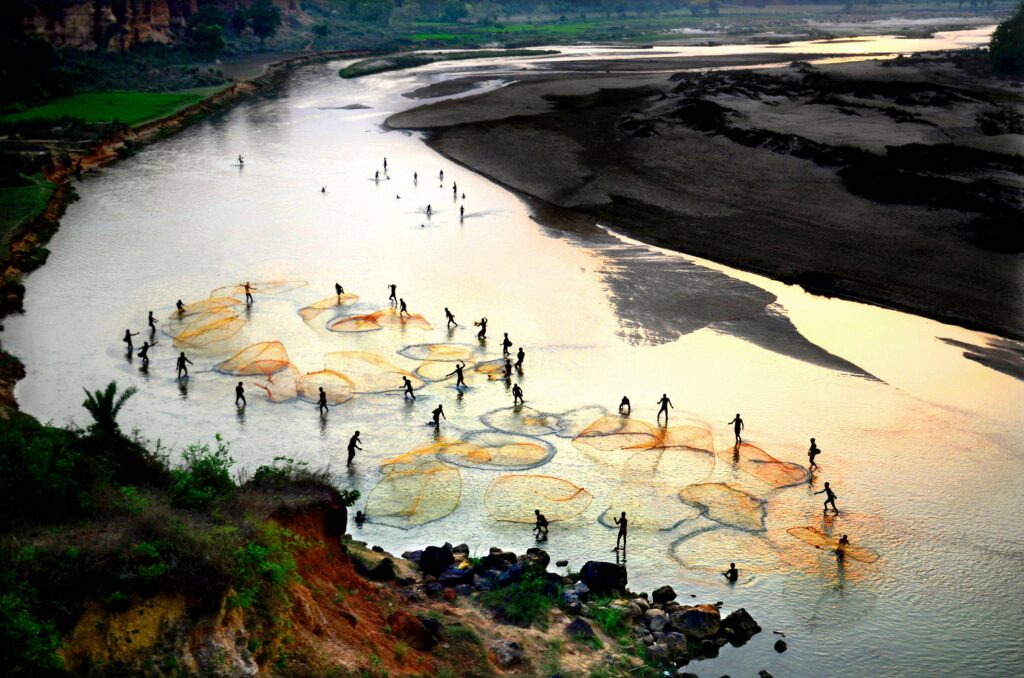 Fishers casting their nets, India.