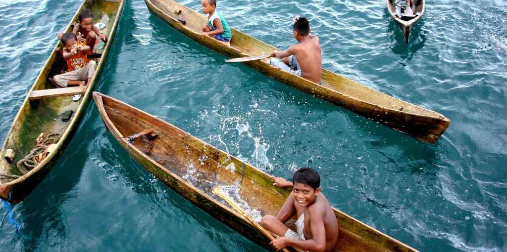 Bajo tribal children (Sea gypsies tribe) in Wakatobi National Park, Southeast Sulawesi, Indonesia. The children play with friends and their “koli-koli” (small wooden boat without engine and screen). This is a common daily activity, along with fishing, for bajo children after returning from school. Photo © Marthen Welly/TNC-CTC